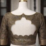 Scalloped back cut blouse design on mannequin with elegant piping and custom tailoring finish