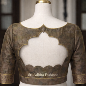 Scalloped back cut blouse design on mannequin with elegant piping and custom tailoring finish