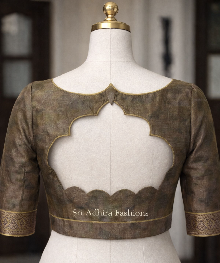 Scalloped back cut blouse design on mannequin with elegant piping and custom tailoring finish