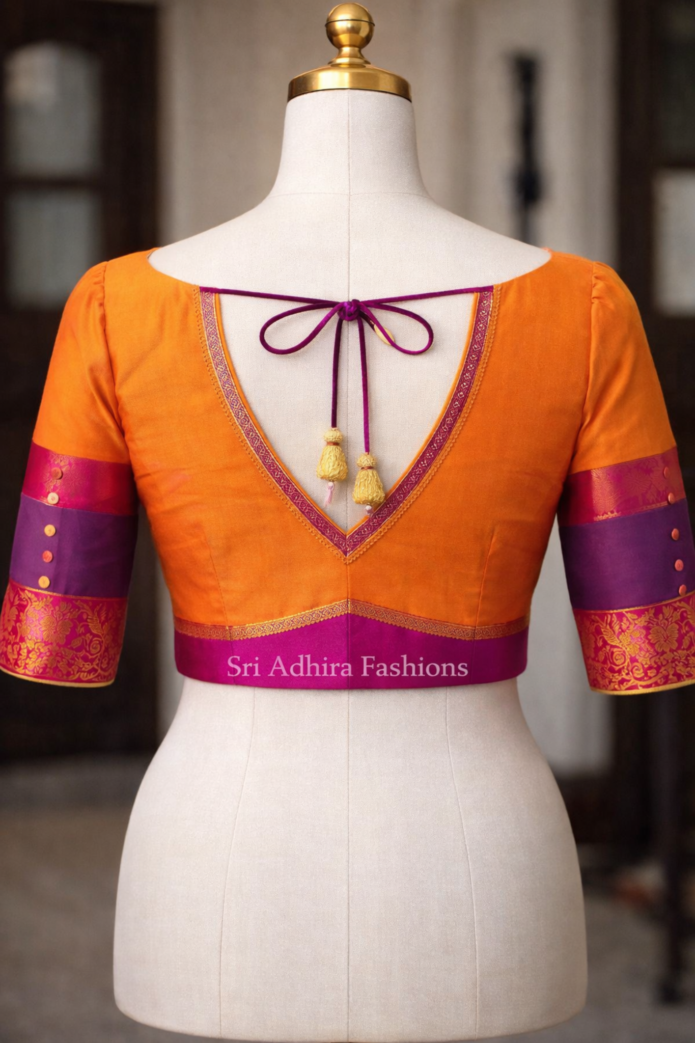 V back tie-up blouse with tassels on mannequin featuring contrast sleeves and custom tailoring design